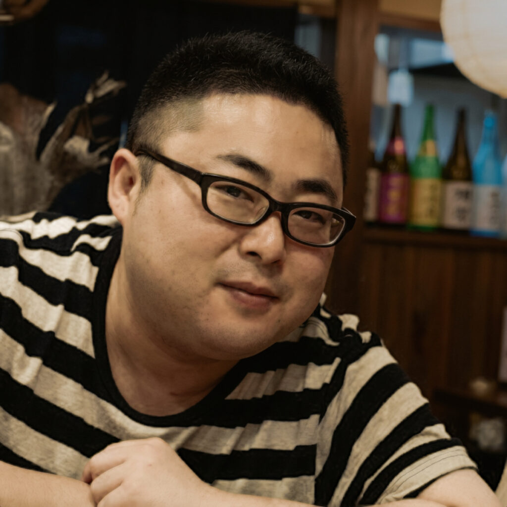 Japanese DJ Marcy smiling at cameras in upper body shot, colour image.