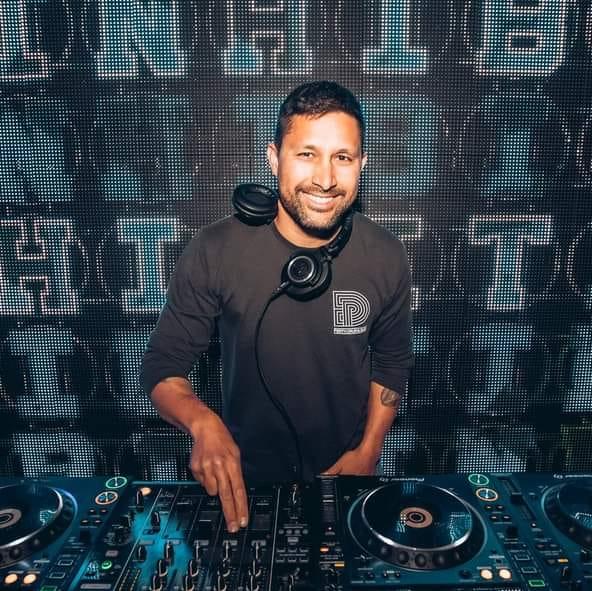 Australian DJ and producer M1dnight performing at an event, colour image.