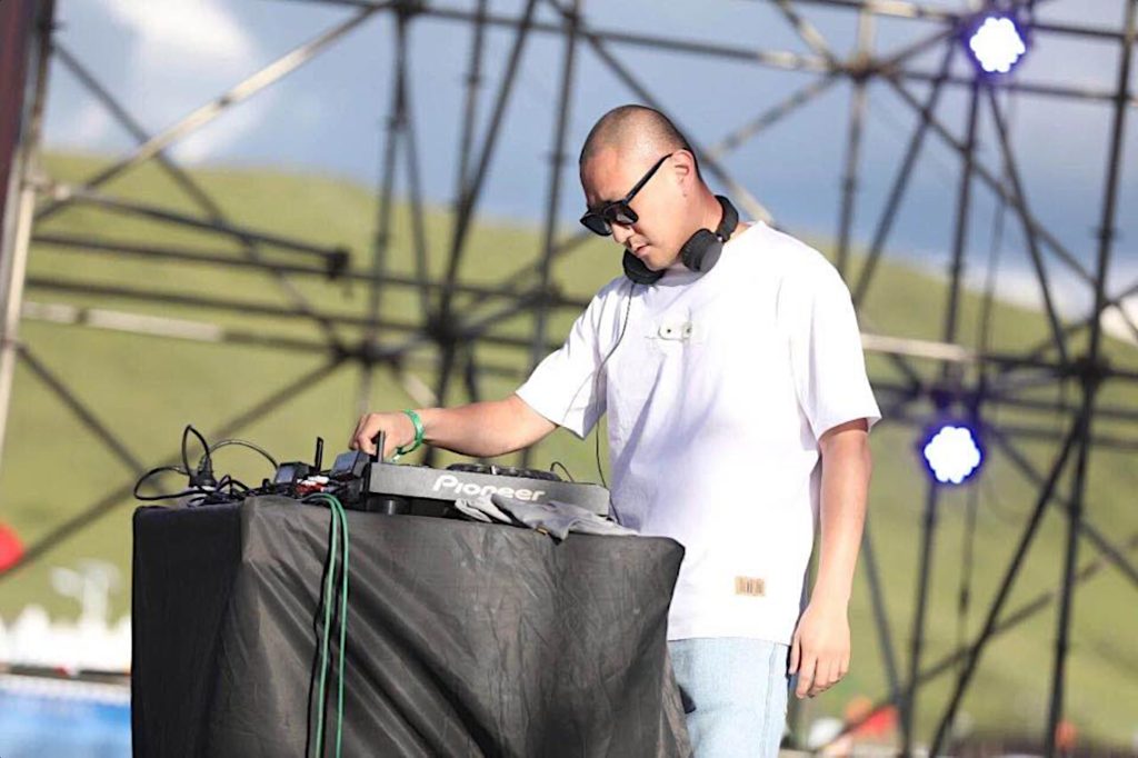 Taiwanese DJ and producer Murphy Kin performing on an outdoor stage in China, colour image.