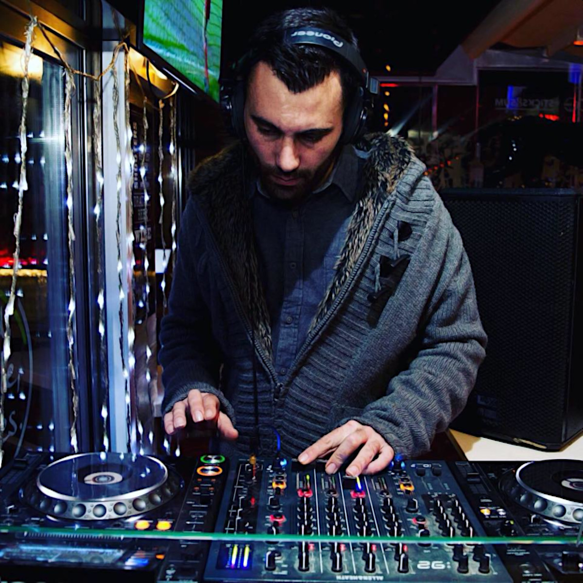 Maltese DJ and Producer Dylan Deck performing on Pioneer CDJs at an event, colour image.