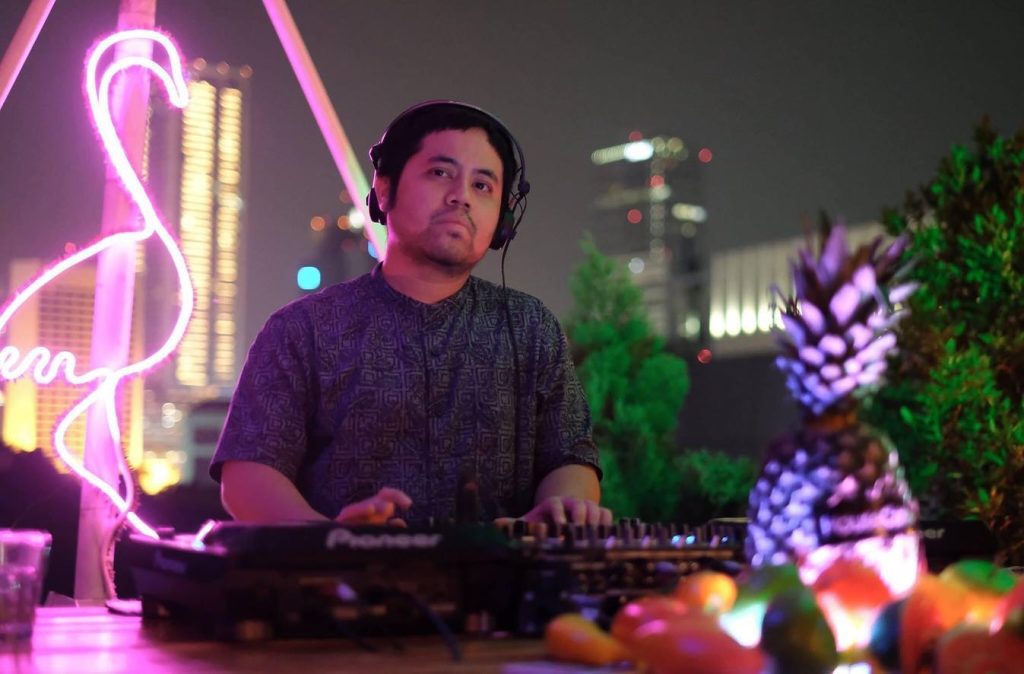 Indonesian DJ and producer Nandi performing at rooftop event in Jakarta, colour image.