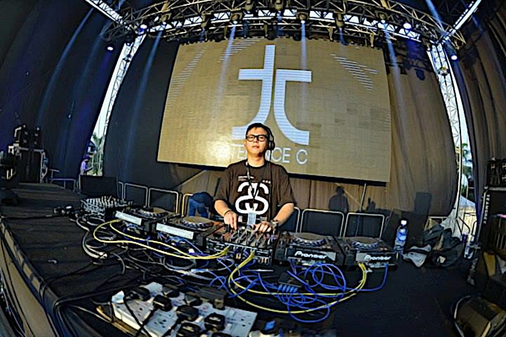Malaysian DJ and producer Terence C performing at an event, colour image.