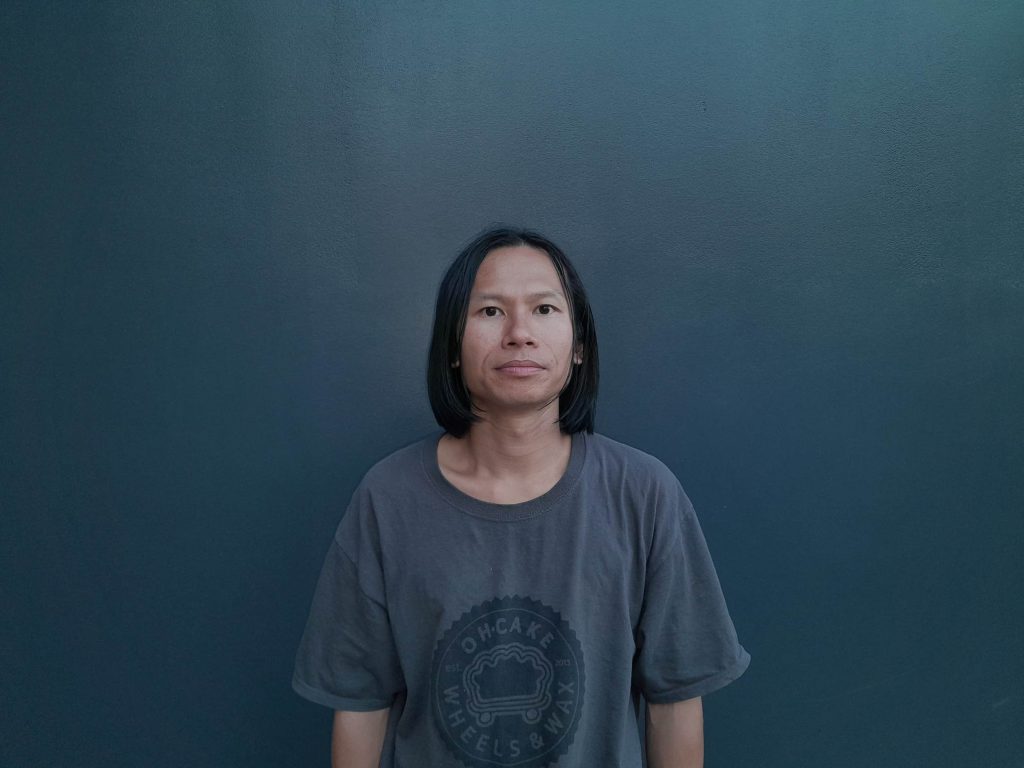 American DJ and producer 6047 in portrait photo looking directly at camera, colour image.