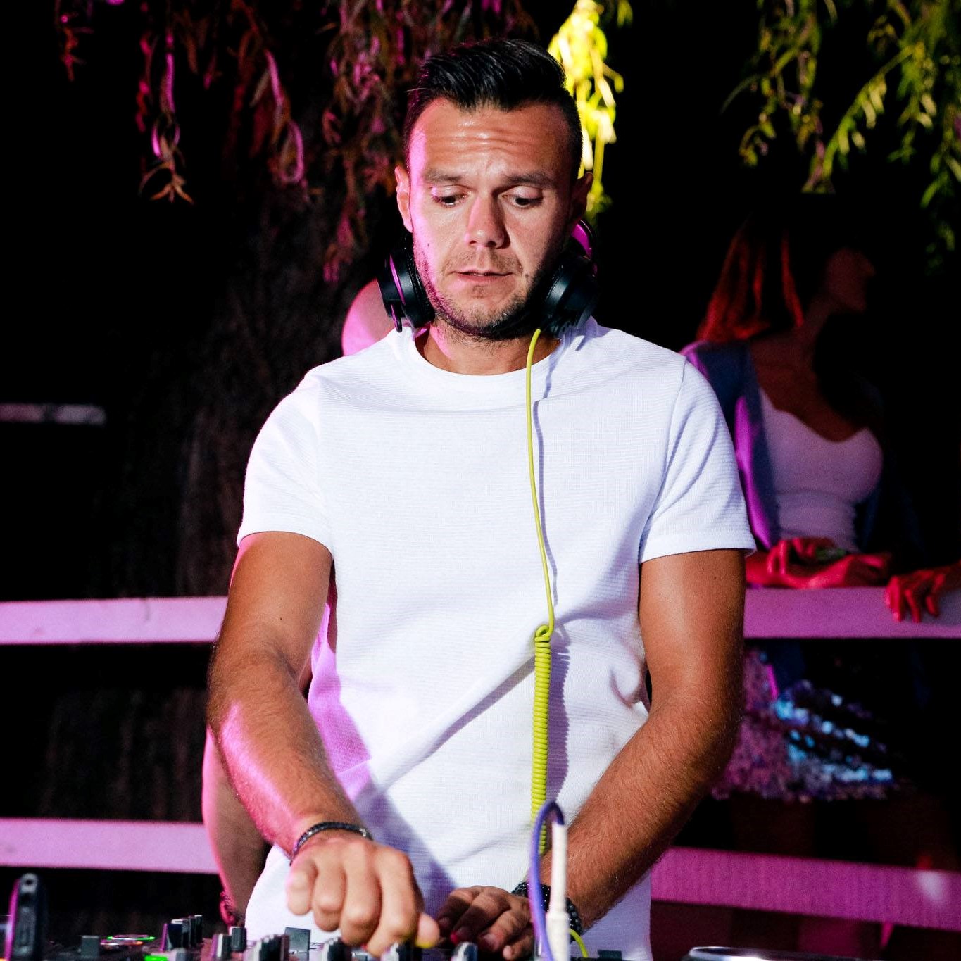 Italian DJ and Producer Andrea Mirgone performing at an event, colour image.