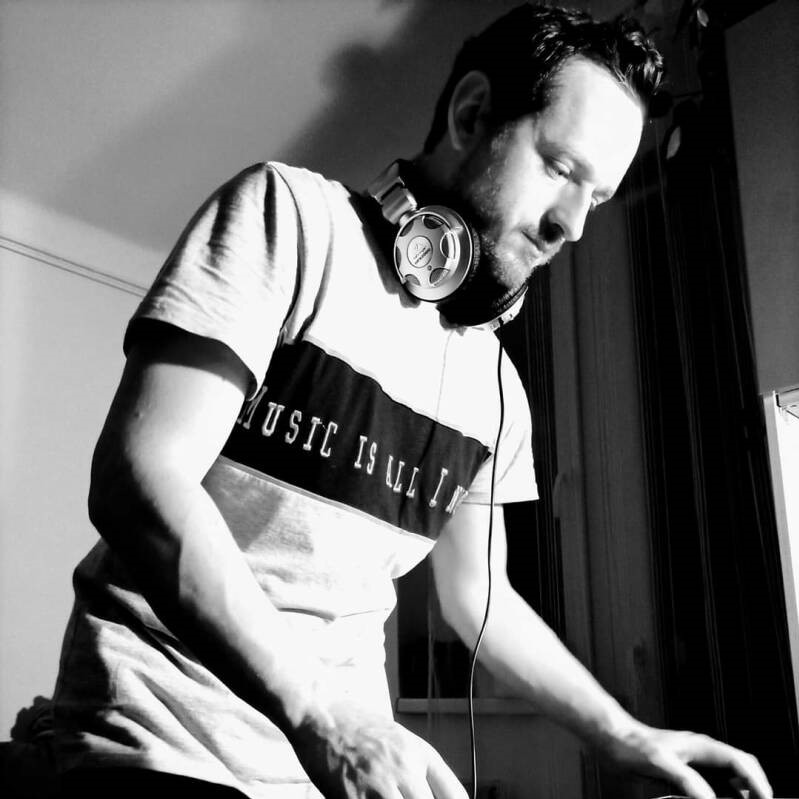 Croatian DJ and producer Tom Cannier in his studio performing, black and white image.