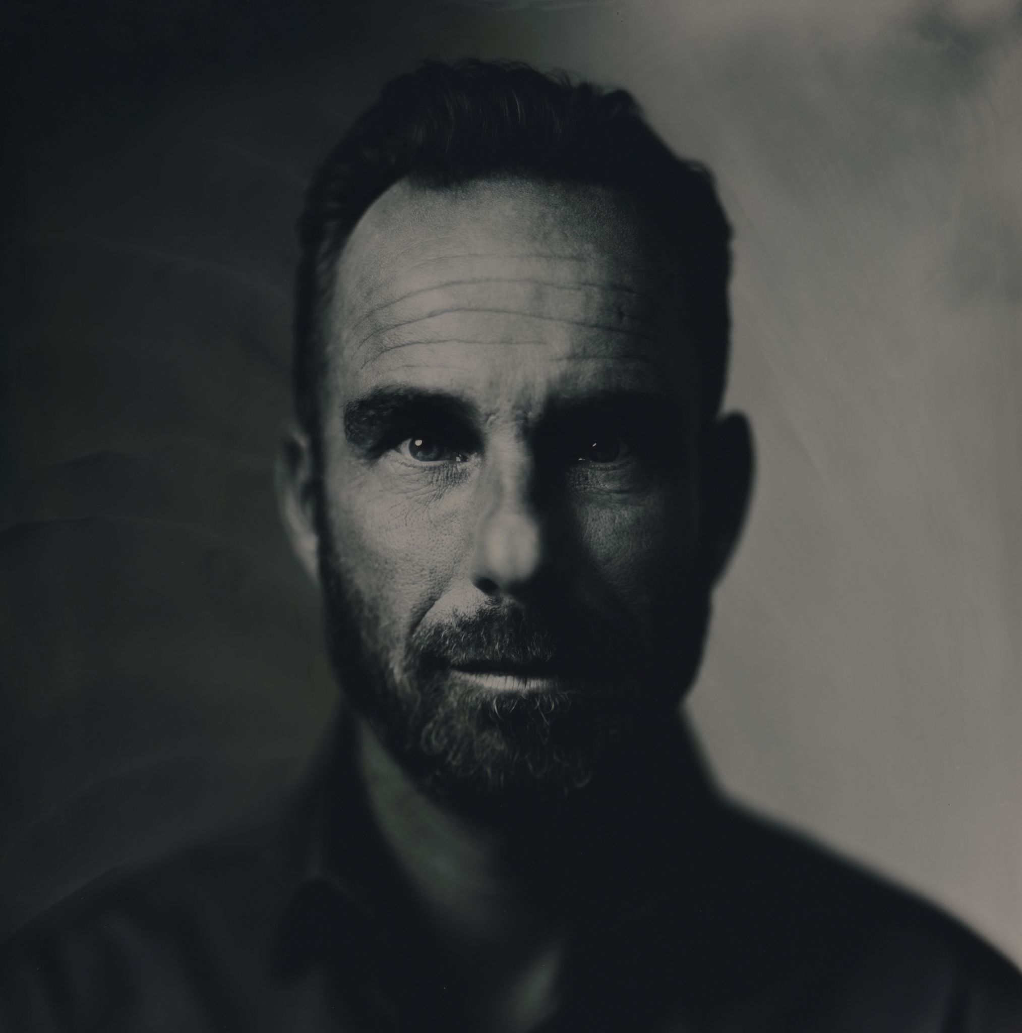 Dutch DJ and Producer Daniel Testas standing looking straight at camera, black and white image.