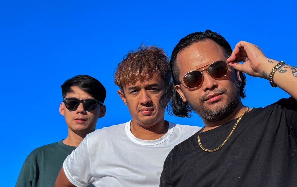 Indonesian band We are Neurotic standing side by side looking at camera, colour image.