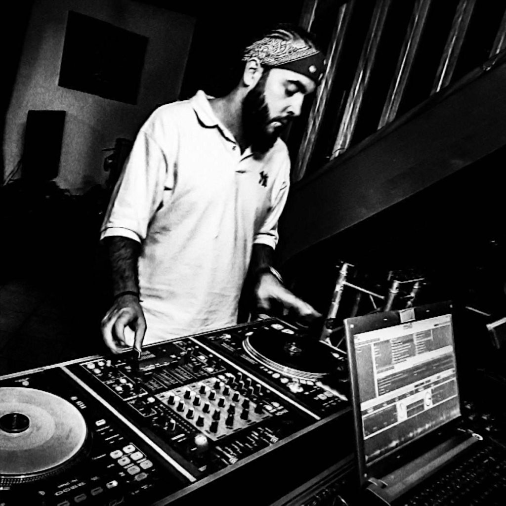 French dJ and producer DJ King Flow performing at an event, black and white image.