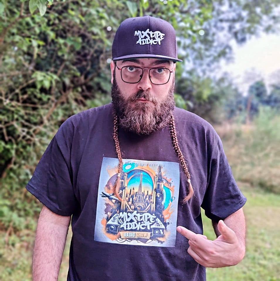 French DJ and producer King Fllow standing wearing a cap looking at camera, colour image.