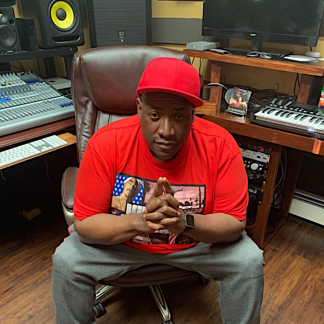 American Hip Hop producer, rapper and label owner D/R Period a.k.a Darryl Pittman sitting in a chair in his recording studio, colour image.