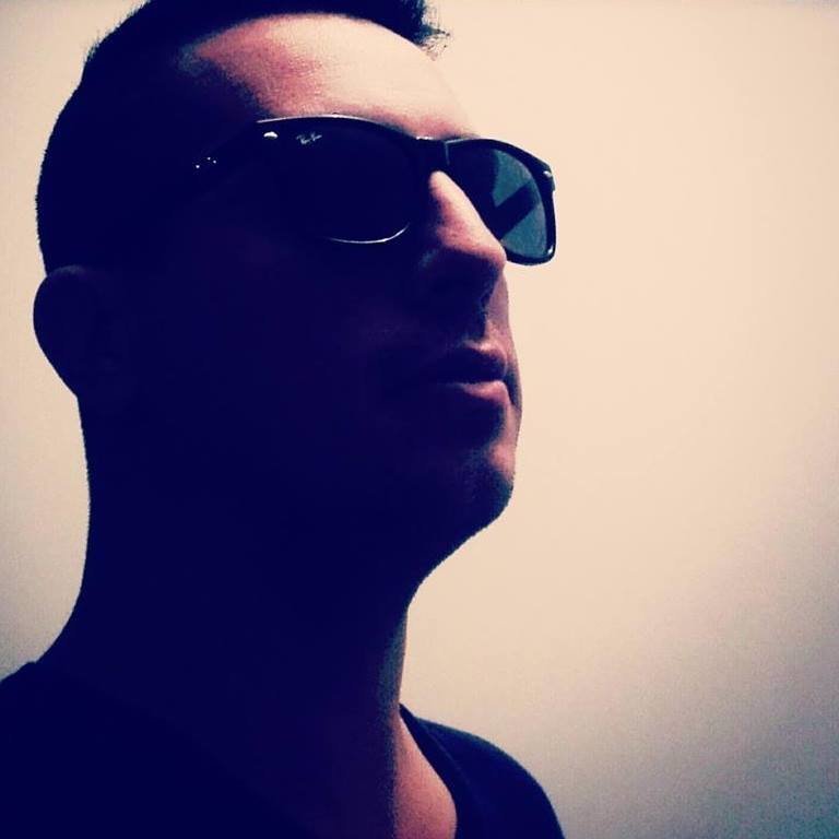 Agentinian DJ and Producer Teleport-X facial shot wearing sunglasses face in shadow.