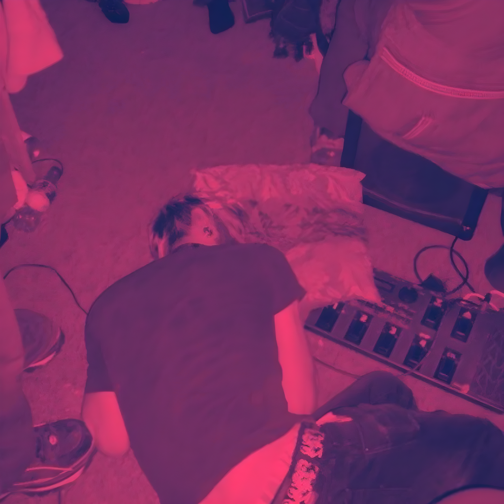 Promotional image for Yushka’s House Party show showing a person asleep on the floor at a house party under pink and purple lighting, surrounded by people, chairs and audio equipment.