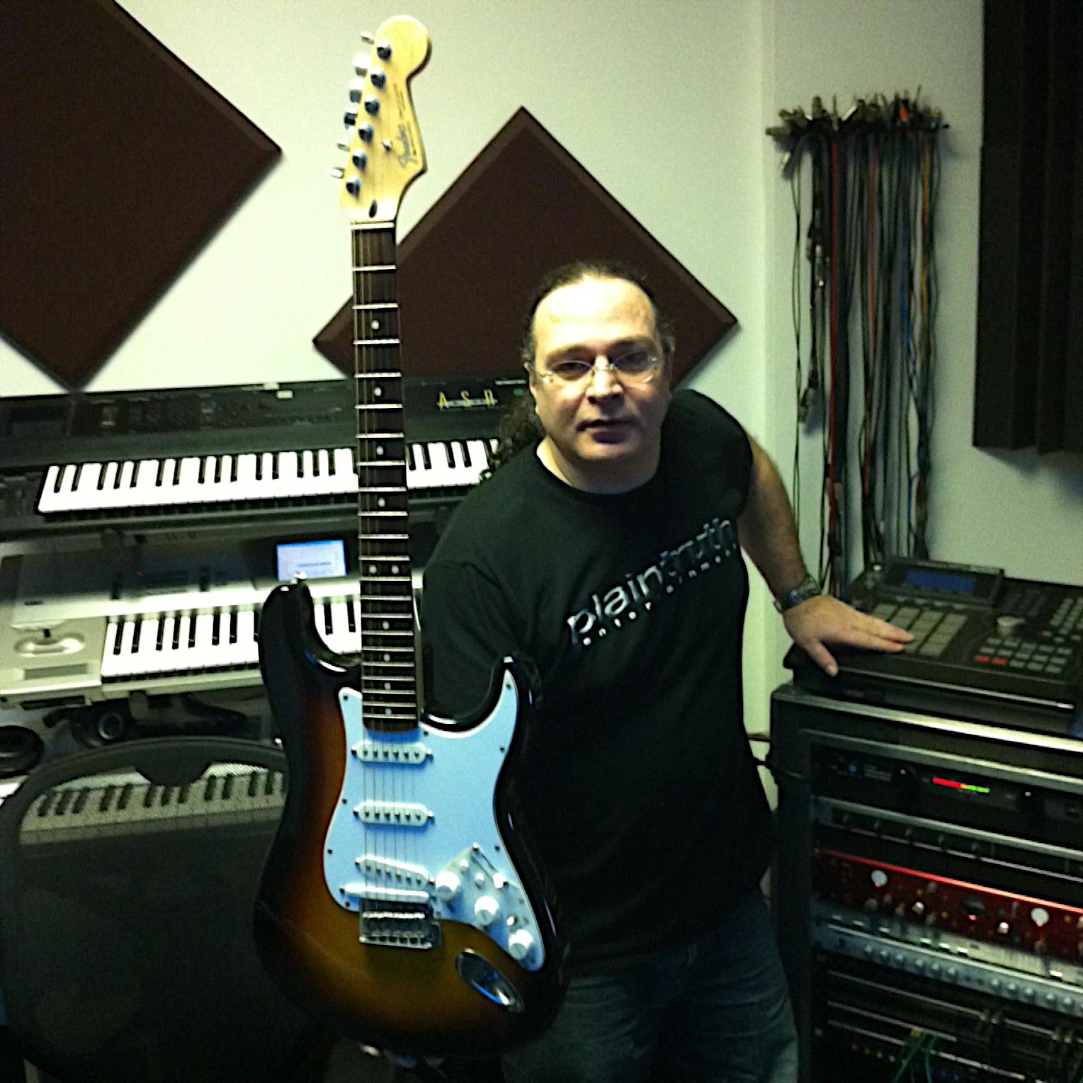 American sound engineer and producer Steve Sola a.k.a The Mix King at Plain Truth Studio holding a guitar, colour image.