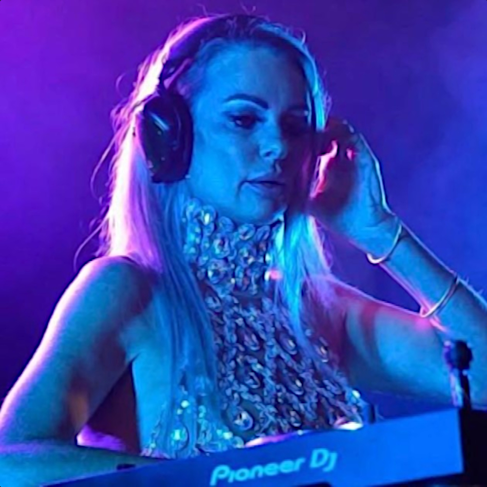 British DJ Sarah Nash performing at an event in Southampton, England, UK, colour image with blue lighting.