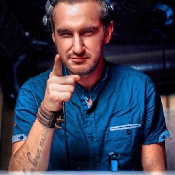Russian DJ and Producer Nodar M sneering at pointing at camera, colour picture.