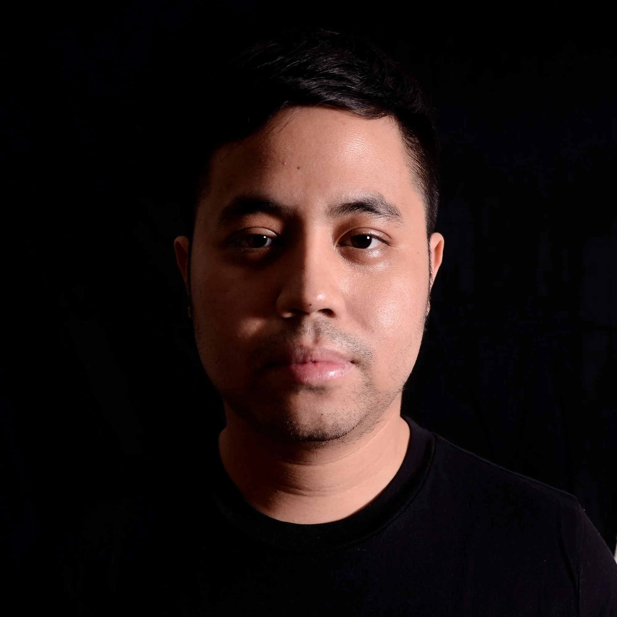 Indonesian DJ Nandi posing for profile picture looking at camera, head shot in colour.