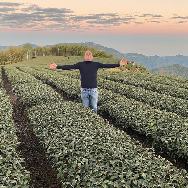 Italian DJ and producer Marco Mei standing in a field with his arms out looking up to sky.
