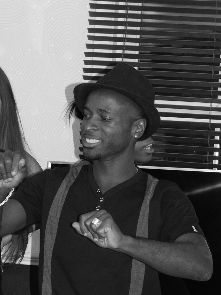 British DJ Frostie dancing whilst wearing a hat, black and white image.