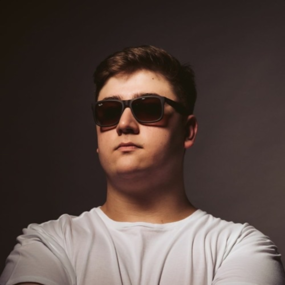 Argentinian DJ and producer Agustin Lupidi standing wearing sunglasses, colour image.