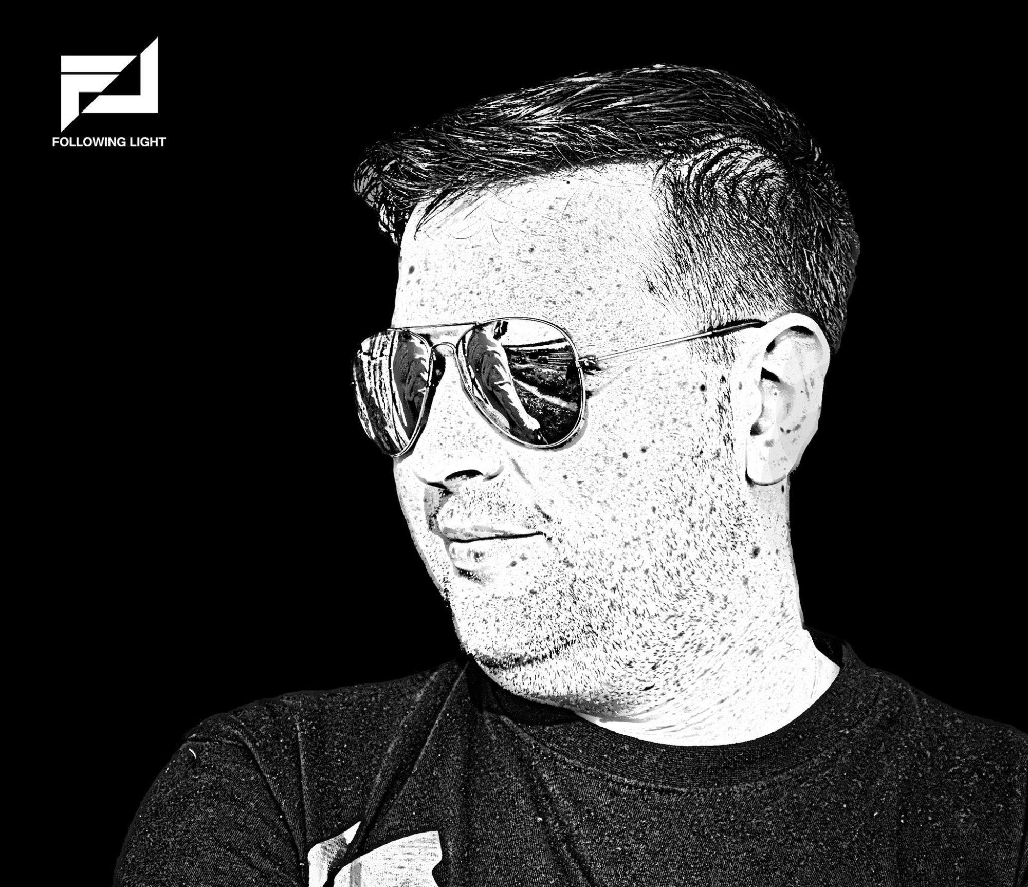 Ukranian DJ and Producer Following Light smiling with head turned to right, black and white image.