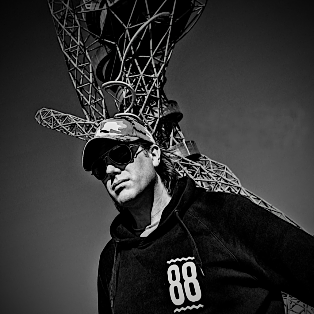 British DJ and producer Blaze DJ standing in front of sculpture, black and white image.