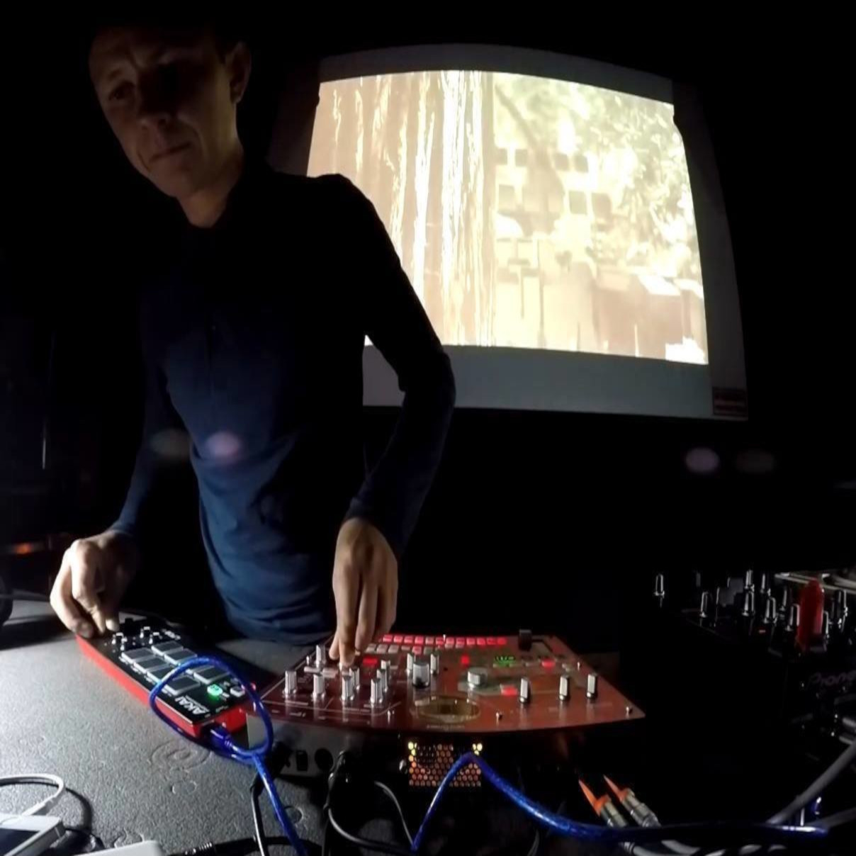 Russsian Dj and producer G-Day performing on production equipment in studio.
