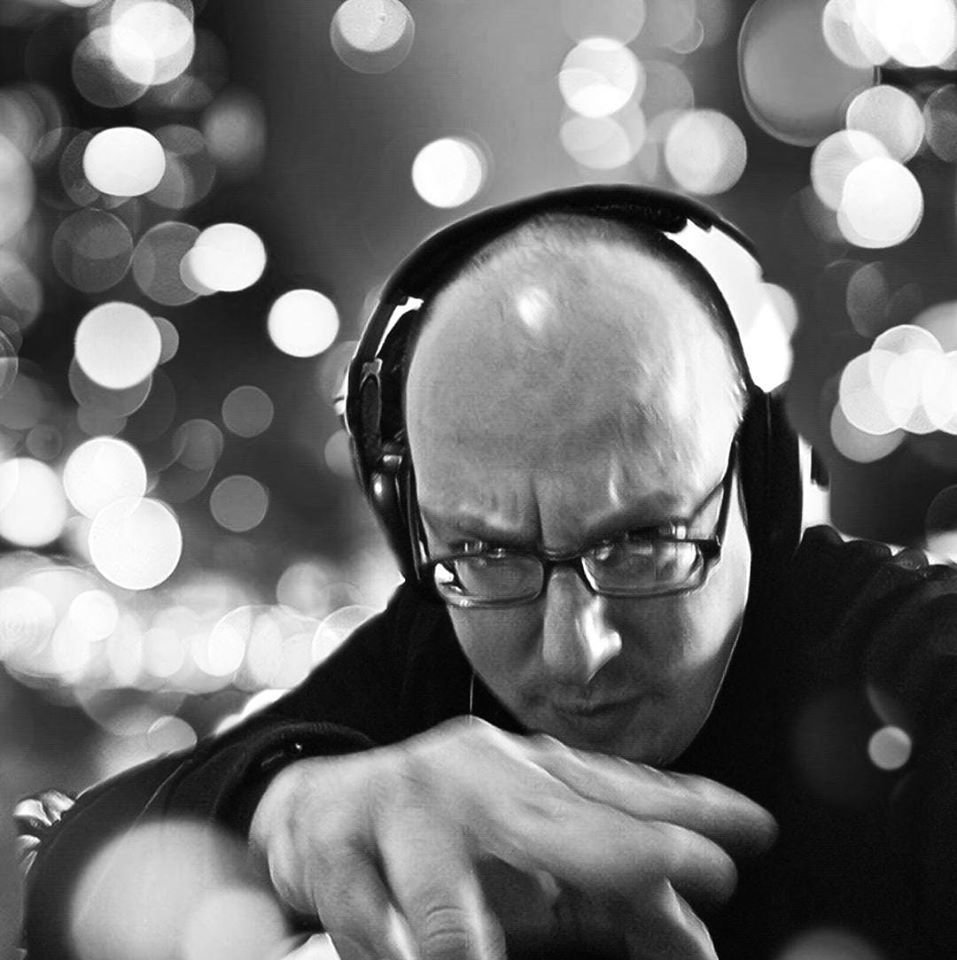 Italian DJ and producer Ugo Anzoino wearing headphones had raised, black and white image.