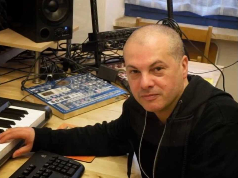 Marco mei Sitting In production studio with hand on Keyboard.