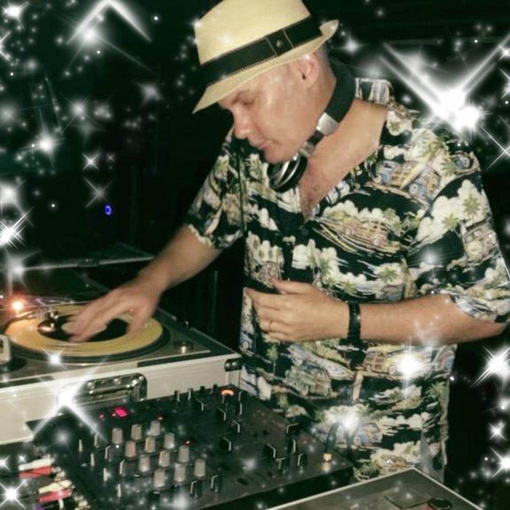 DJ Andrew M wearing a hat whilst performing as a Vinyl DJ on Technics SL1200 Turntables.