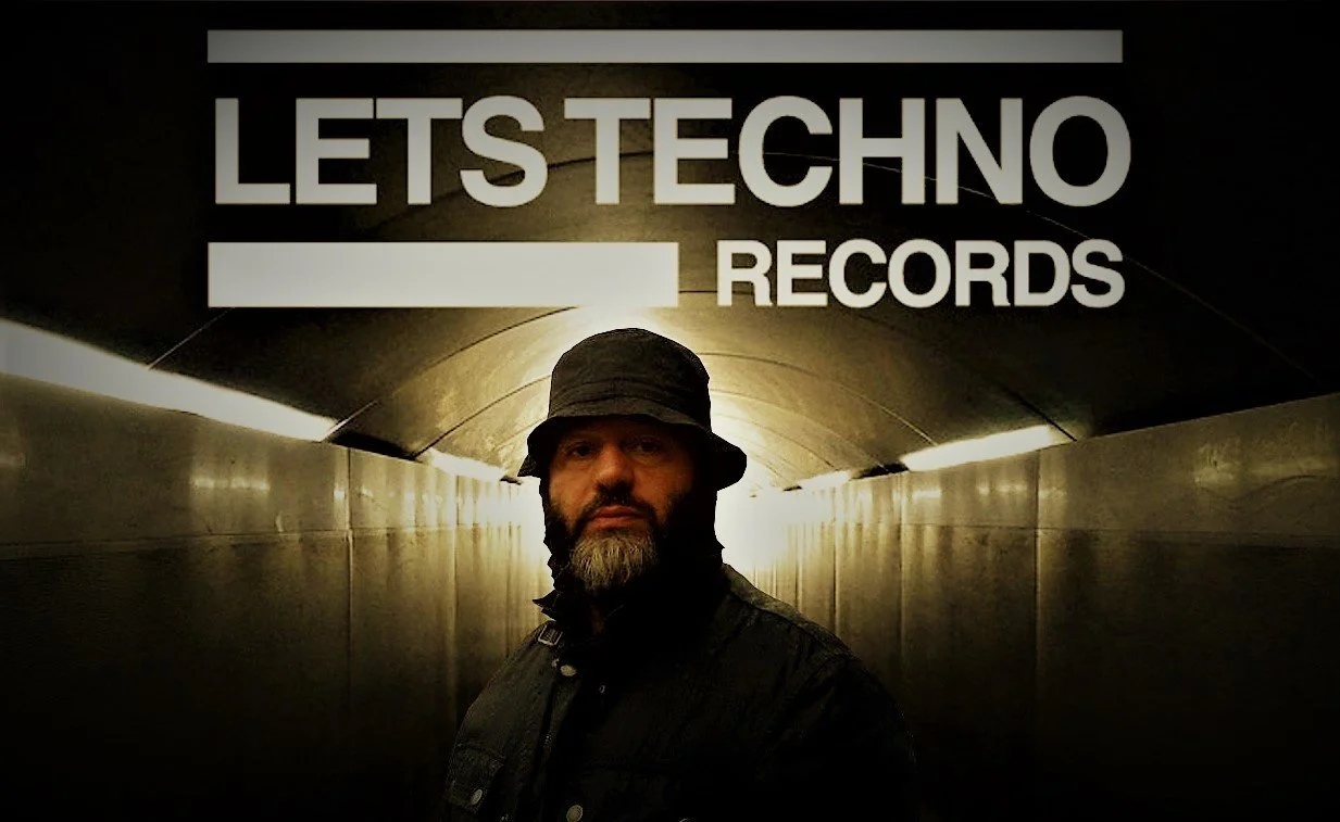 LETS Techno CEO Ricky Busta standing in a tunnel wearing a hat with his logo above his head in a colour image.