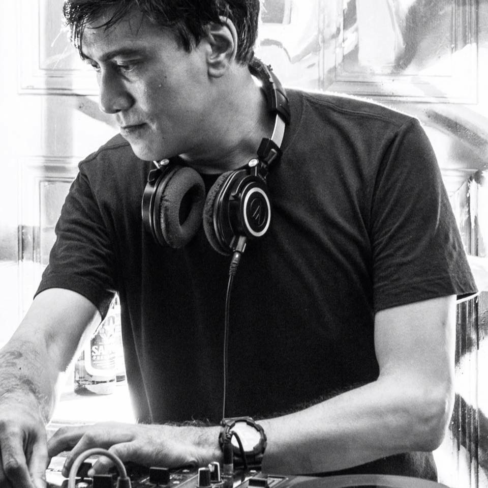 Singaporean DJ and producer Brendon P performing at an event, black and white image.