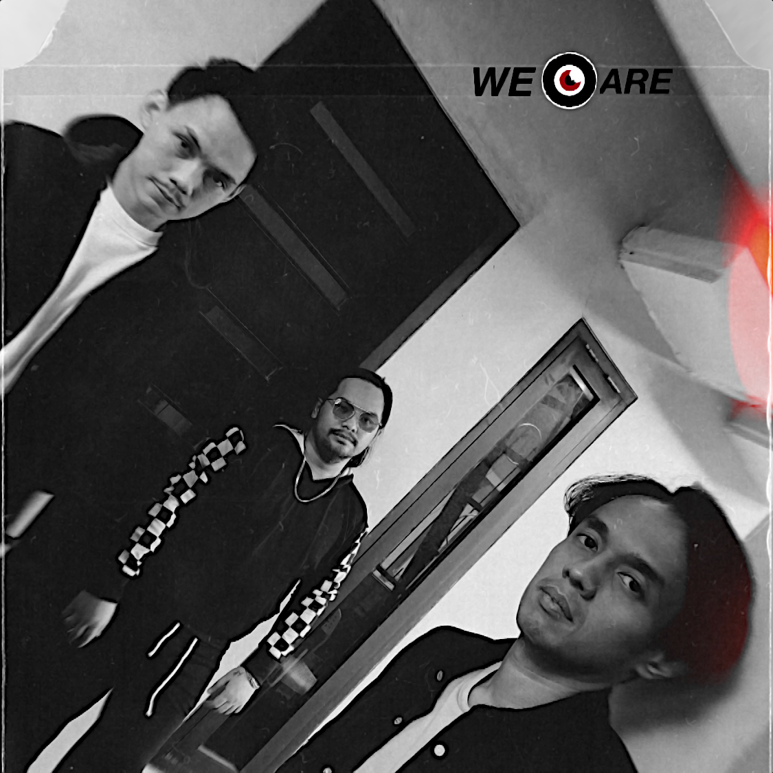 Indonesian DJ and production trio We Are Neurotic standing looking at the camera in an angled shot, black and white image.