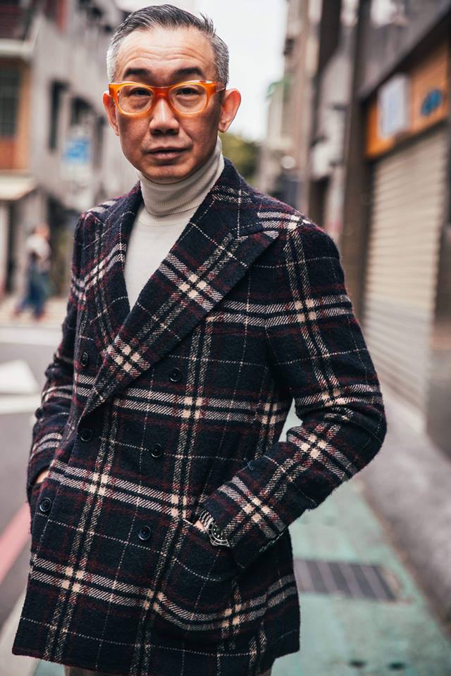 Taiwanese DJ Louis Chen Standing and Wearing a Tartan Coat.