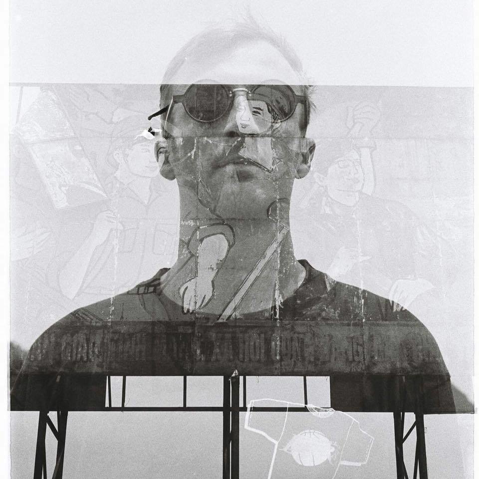 Halographic image of DANE superimposed on Vietnamese workers advertisement, image in black and white.