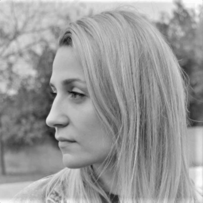 Polish DJ and producer Nowa standing and facing her head right in a black and white headshot photo.