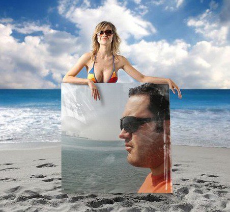 Portuguese DJ Joshua on a picture banner on beach being held by a beach girl in bikini, colour image.