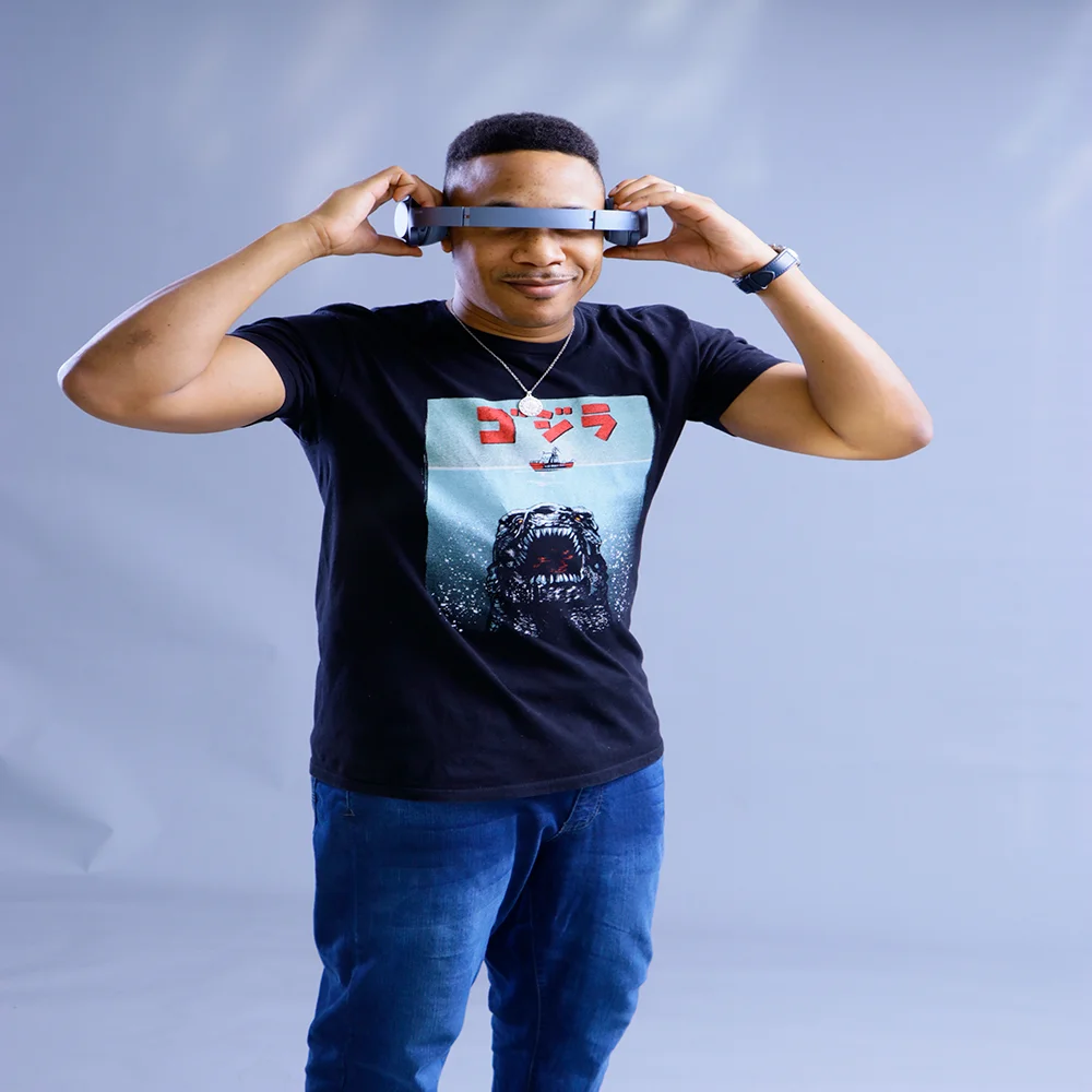 American DJ and producer Gerard coving his eyes with headphone band, colour image.