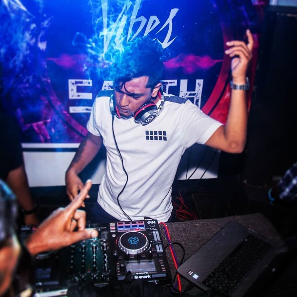 Sri Lankan DJ Praj Vibes performing at an event with Numark DJ equipment.