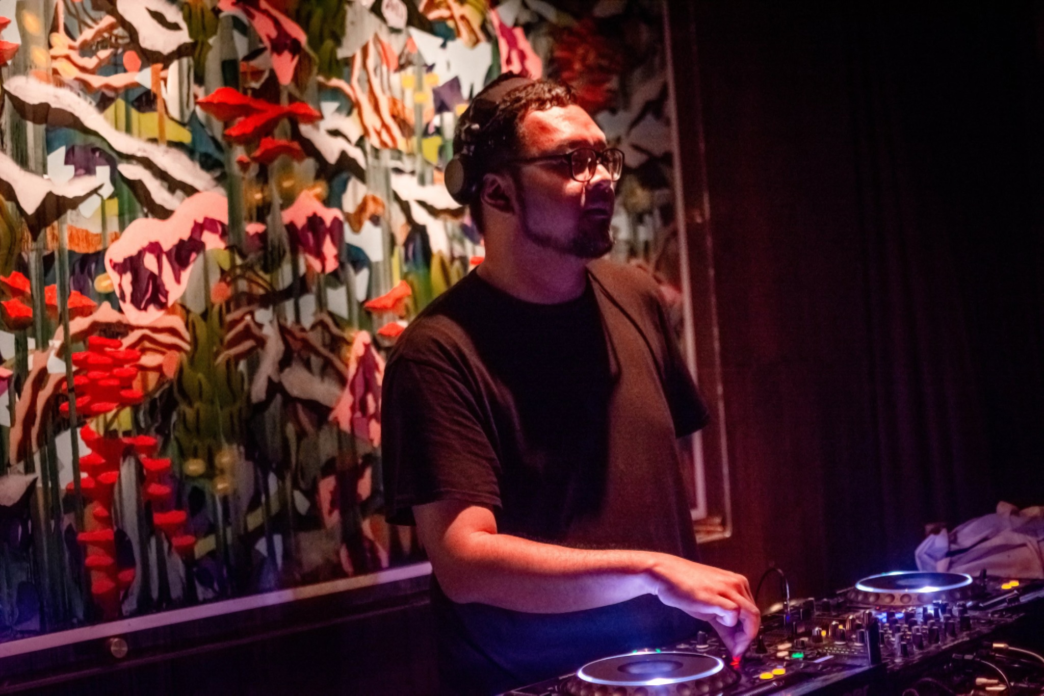 Indonesian DJ and producer Yorri performing on Pioneer CDJs and Mixer, colour image.