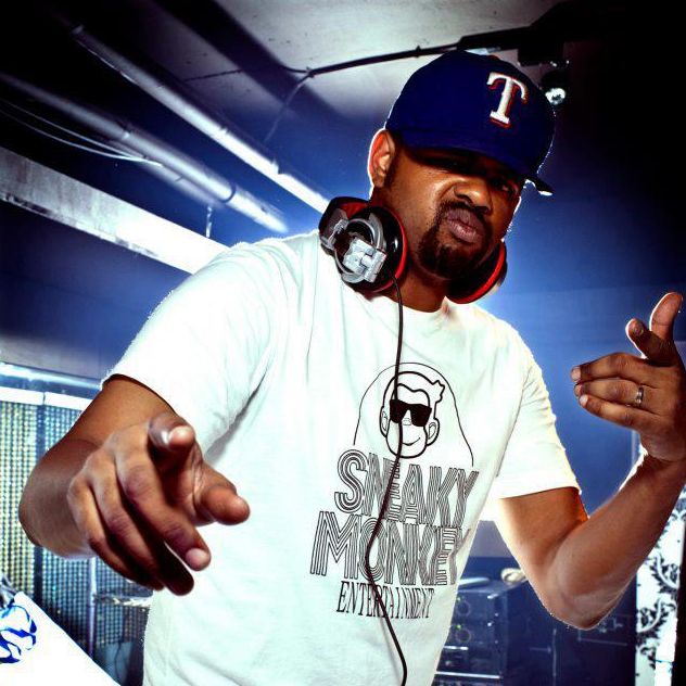 American DJ and producer Digital D wearing headphones and Baseball cap pointing at camera with both fingers, colour image.