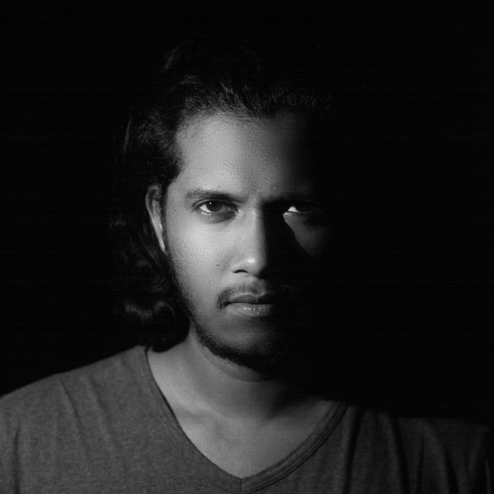 Sri Lankan DJ and producer VeeQué in a portrait shot staring at the camera, black and white image.