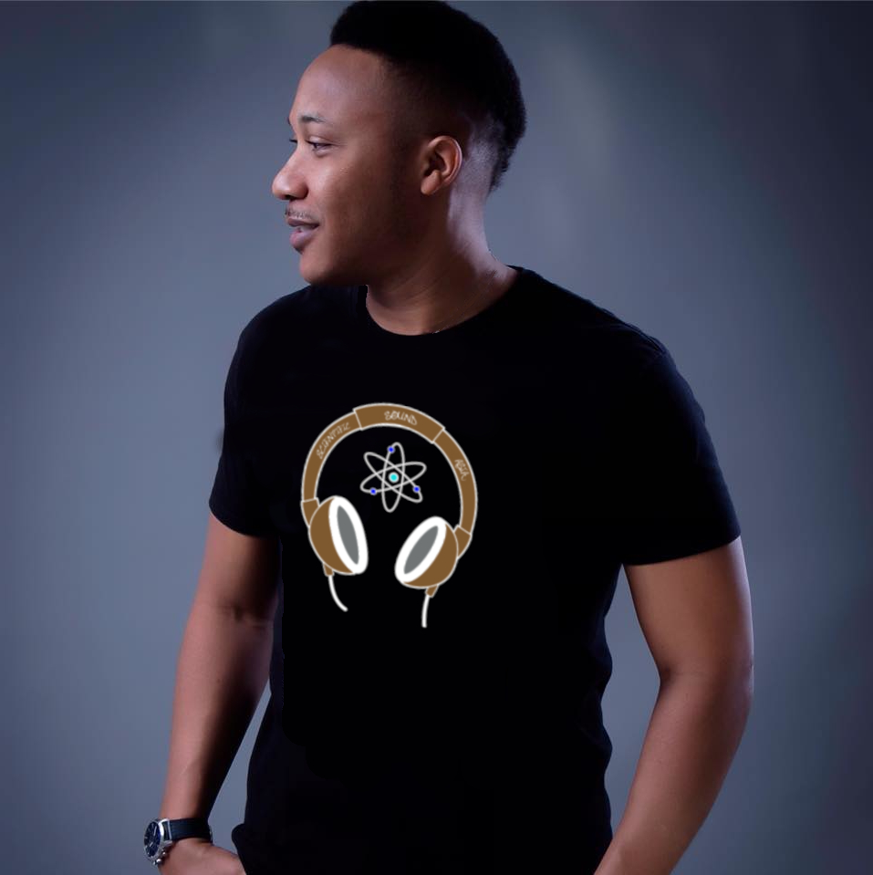American DJ and Producer Gerard Standing with hnads in pockets looking right whilst wearing a Scientific Sound Asia T-Shirt, colour image.
