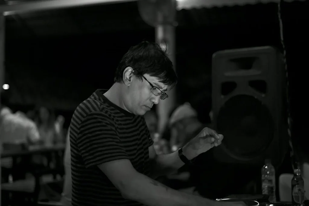 Singaporean DJ and producer Brendon P performing at an event, black and white photo.
