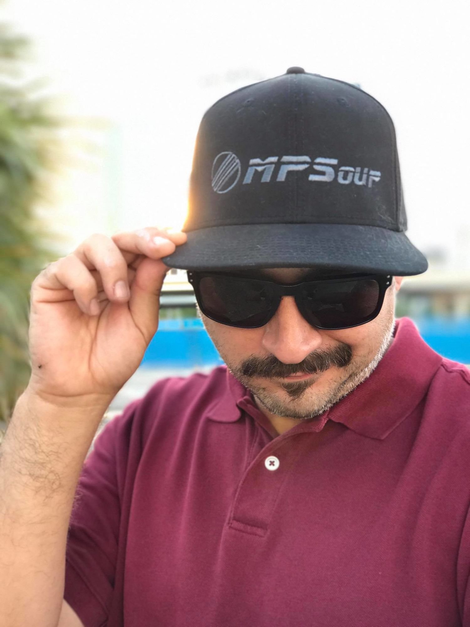 Guest DJ MPSoup wearing logo Baseball Cap and sunglasses.