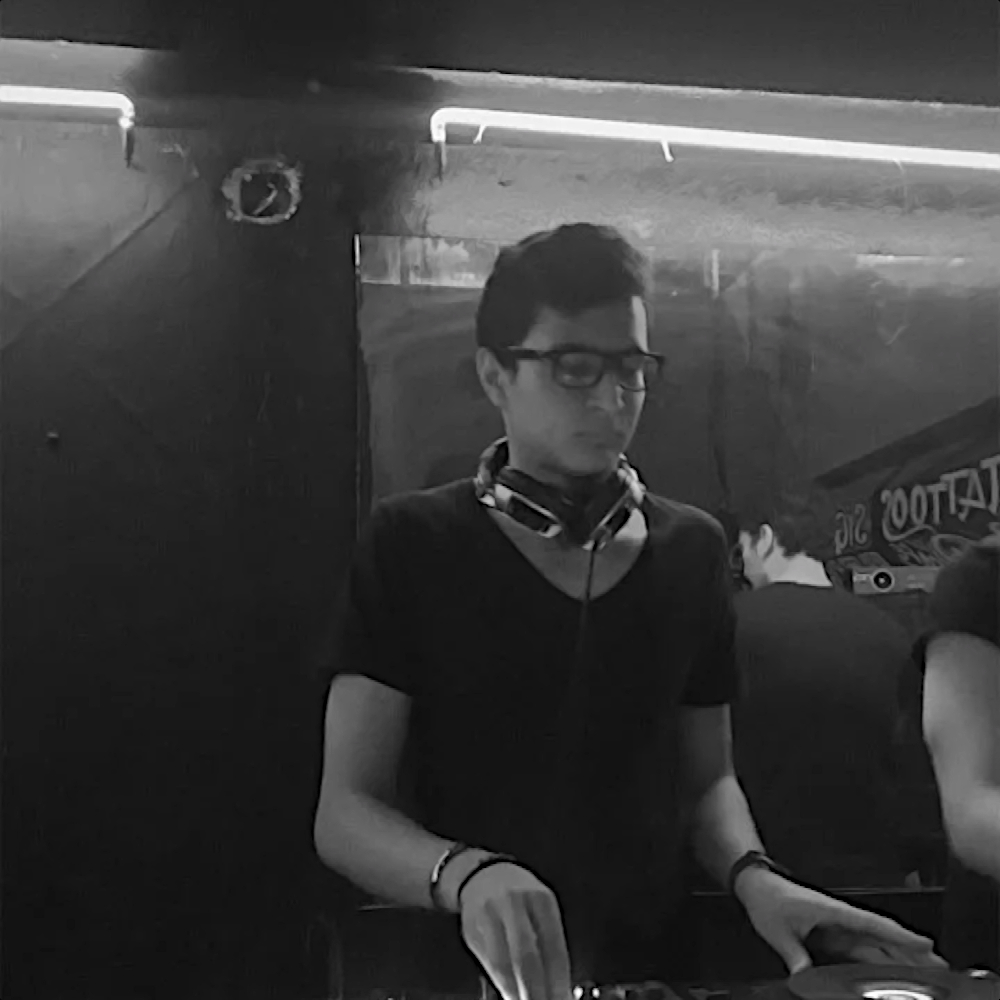 Guest DJ Deico a.k.a Solomon Bosk & aka.000.co performing at an event, black and white image.