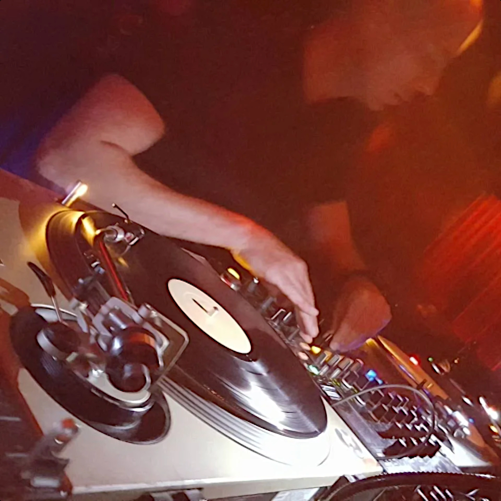 Dutch DJ Reinoud van Toledo performing on Technics SL 1200 turntables in Amsterdam, colour image.
