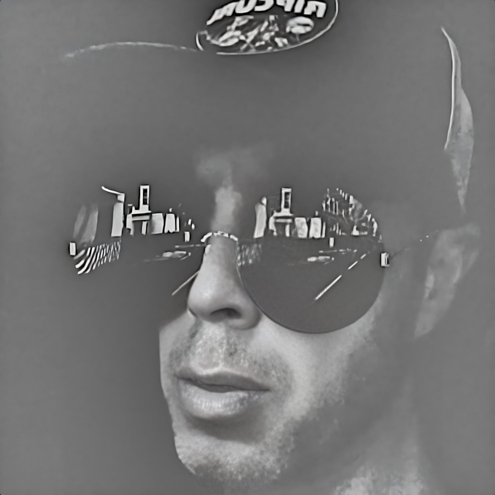 Black-and-white portrait of Dutch DJ and producer Reinoud van Toledo wearing sunglasses, representing his long-running work across House and Techno.
