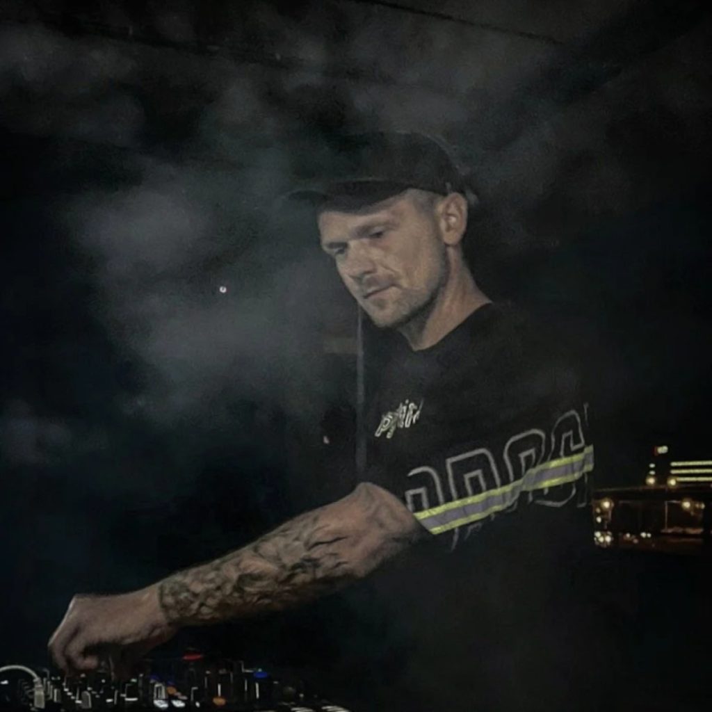 Belarusian DJ Igor Hush performing as a DJ at an event, colour image.