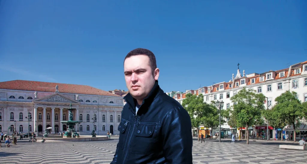 Portuguese DJ Joshua standing in Evora portugal in a square, colour image.