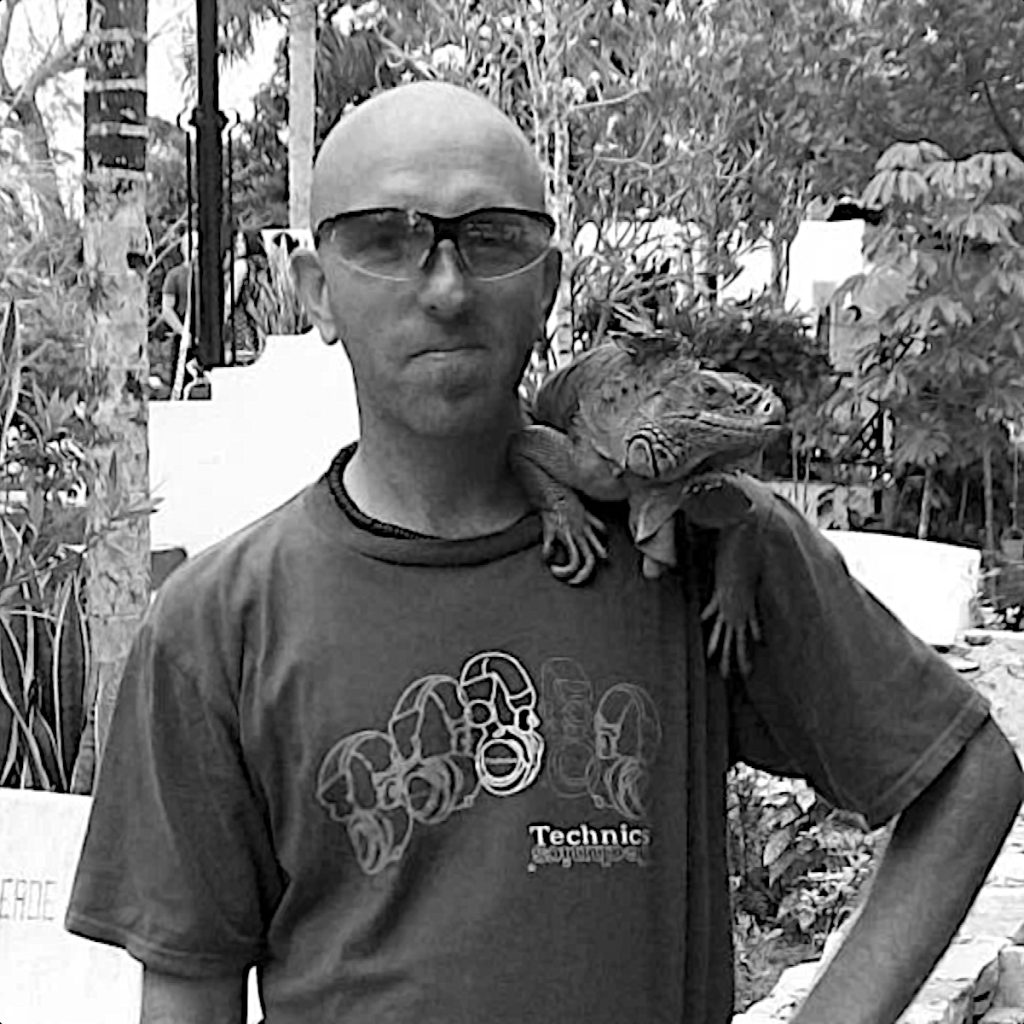 British DJ and promoter Jonni Hey standing with a lizard on his shoulder, black and white image.